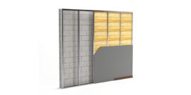 Wall assembly featuring metal stud framing with insulation and partially installed gypsum board over a masonry wall.